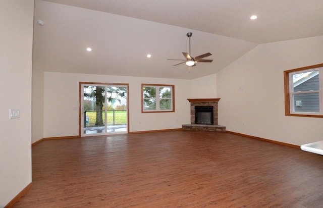 unfurnished living room with ceiling fan, a fireplace, wood-type flooring, and vaulted ceiling