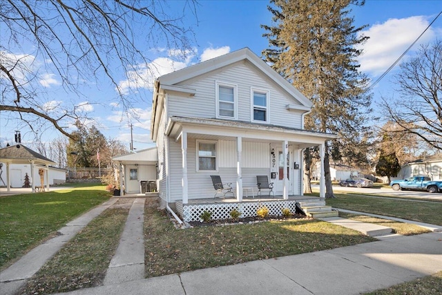 view of front of property with covered porch and a front lawn