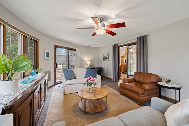 carpeted living room featuring ceiling fan