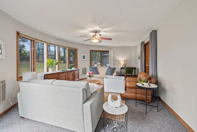 carpeted living room featuring ceiling fan and a wealth of natural light