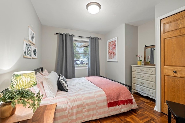 bedroom with dark parquet floors