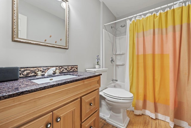 full bathroom with vanity, toilet, wood-type flooring, and shower / tub combo