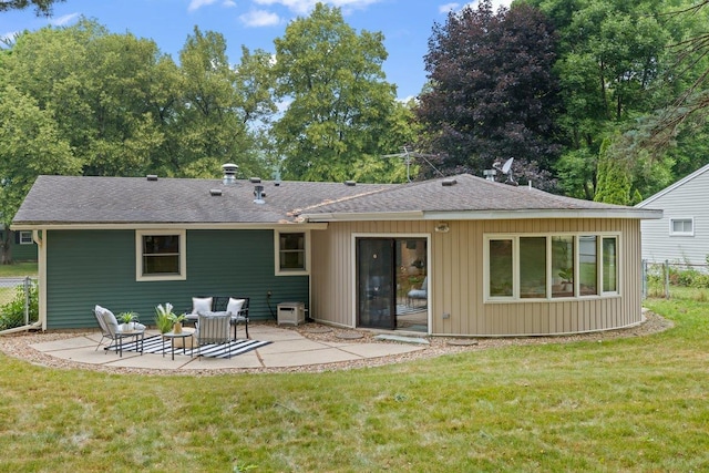 back of property featuring a yard and a patio