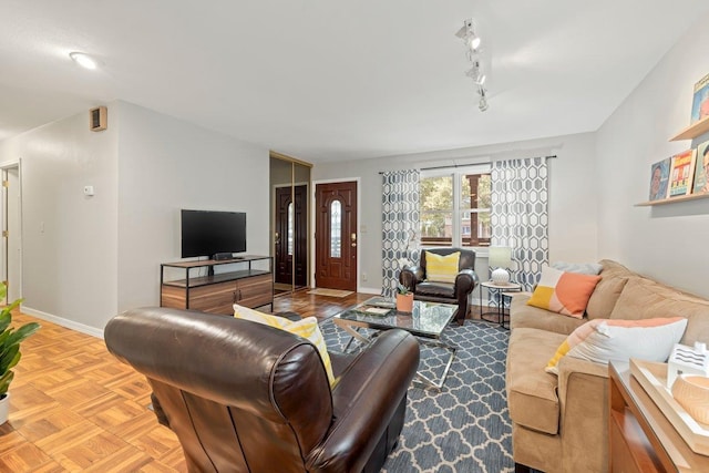 living room featuring light parquet floors and rail lighting