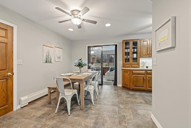 dining space featuring baseboard heating and ceiling fan