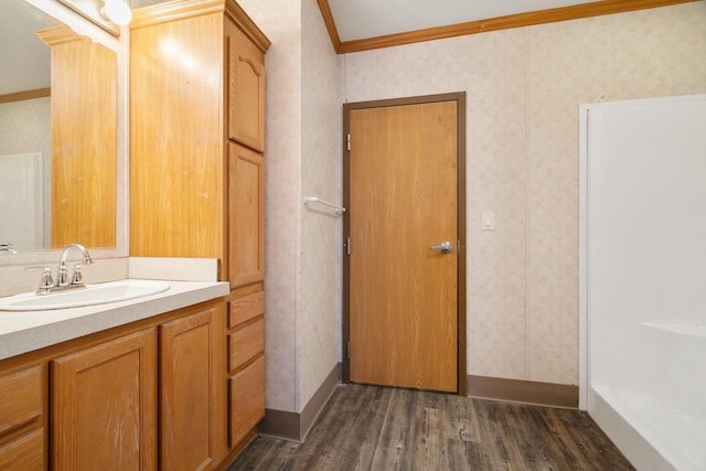 bathroom with crown molding, vanity, and wood-type flooring