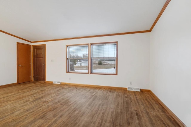 unfurnished room with wood-type flooring and crown molding