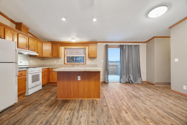 kitchen featuring hardwood / wood-style floors, white appliances, and a kitchen island