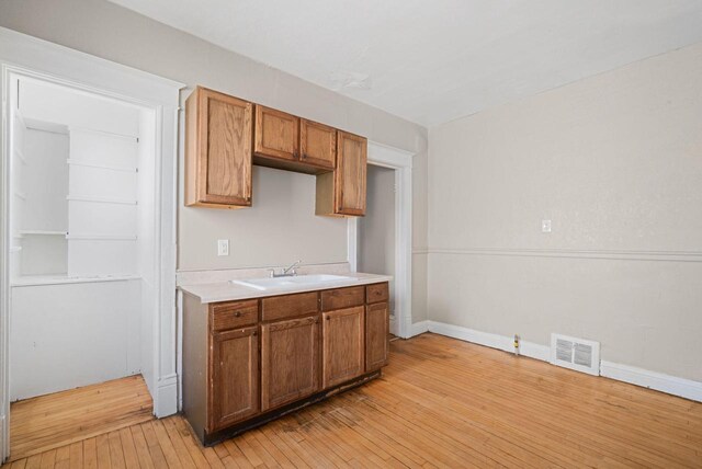 kitchen featuring light wood-type flooring and sink