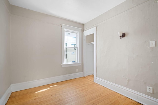 spare room featuring wood-type flooring