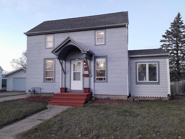 view of front of home with an outbuilding, a garage, and a front yard