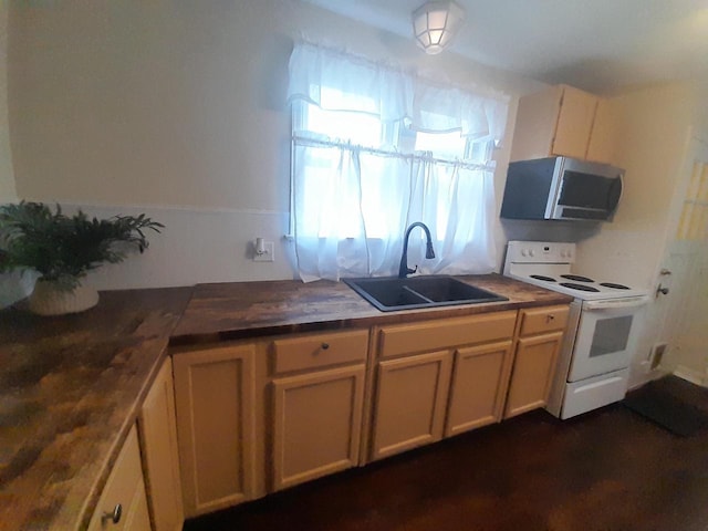 kitchen featuring wood counters, white range with electric stovetop, and sink