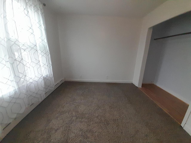 unfurnished bedroom featuring dark colored carpet