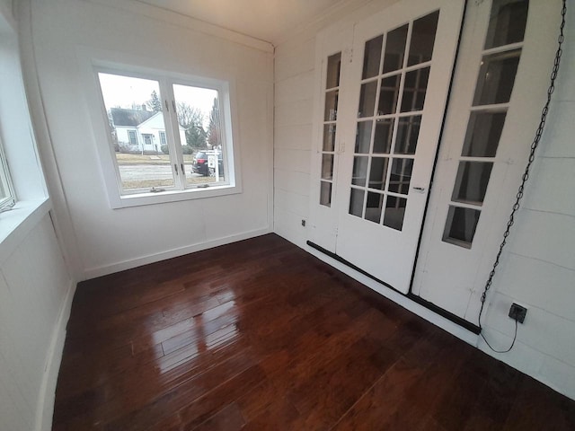 empty room featuring crown molding and dark hardwood / wood-style flooring