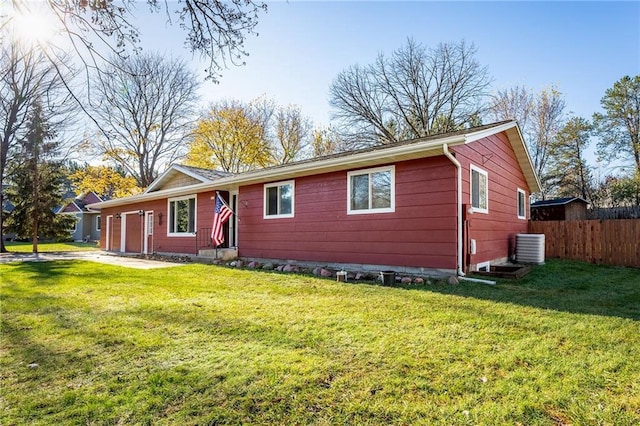 single story home with a front yard and central AC