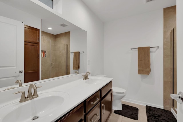 bathroom with tile patterned flooring, vanity, toilet, and walk in shower