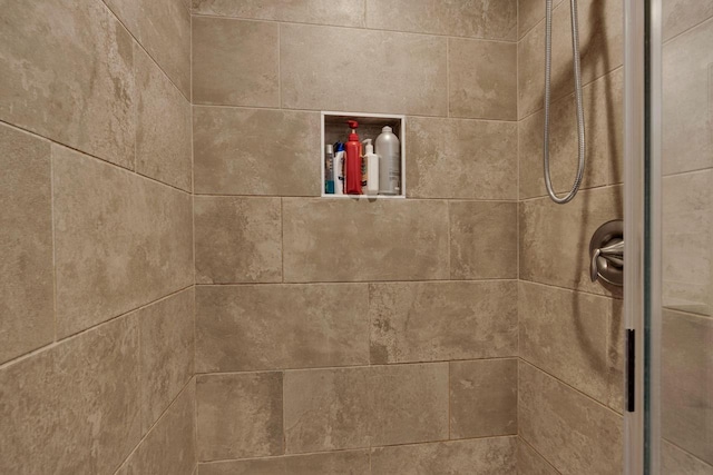 interior details with a tile shower