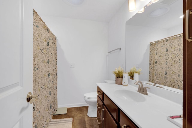 bathroom featuring hardwood / wood-style floors, vanity, and toilet