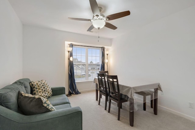 carpeted dining room featuring ceiling fan