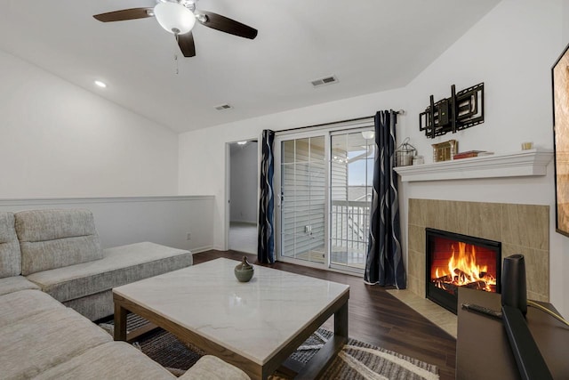 living room with a fireplace, dark hardwood / wood-style floors, ceiling fan, and lofted ceiling