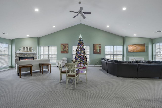 dining space featuring a healthy amount of sunlight, light colored carpet, and a fireplace