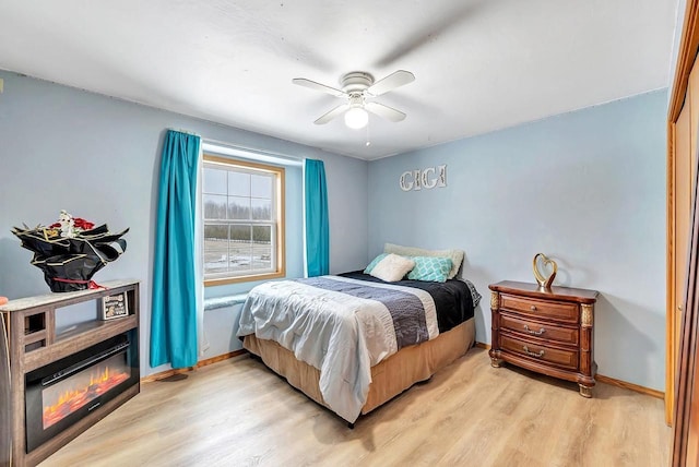 bedroom with ceiling fan and light wood-type flooring