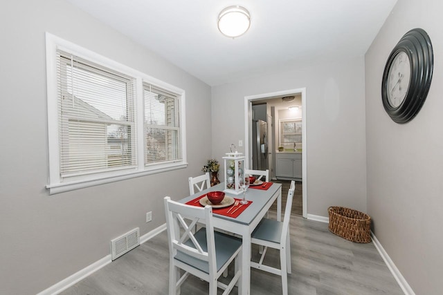 dining area with light wood-type flooring