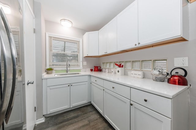 kitchen featuring white cabinets, dark hardwood / wood-style floors, a healthy amount of sunlight, and sink