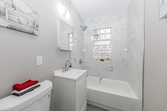 full bathroom with vanity, toilet, and tiled shower / bath combo