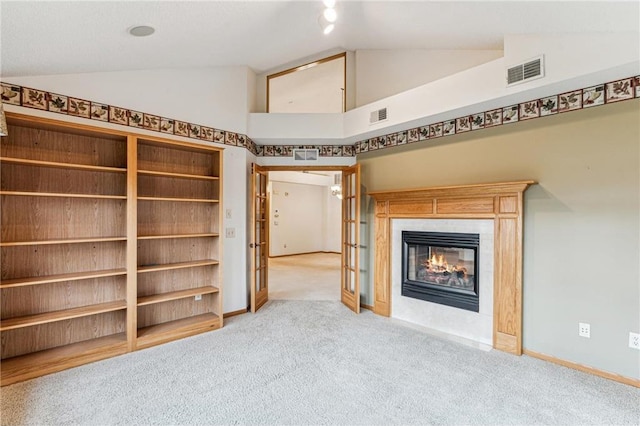 unfurnished living room featuring high vaulted ceiling, built in features, and light carpet