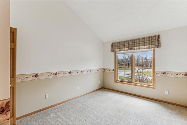 unfurnished room with lofted ceiling and carpet floors