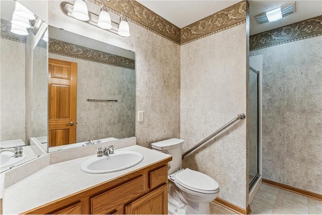 bathroom featuring an enclosed shower, vanity, and toilet