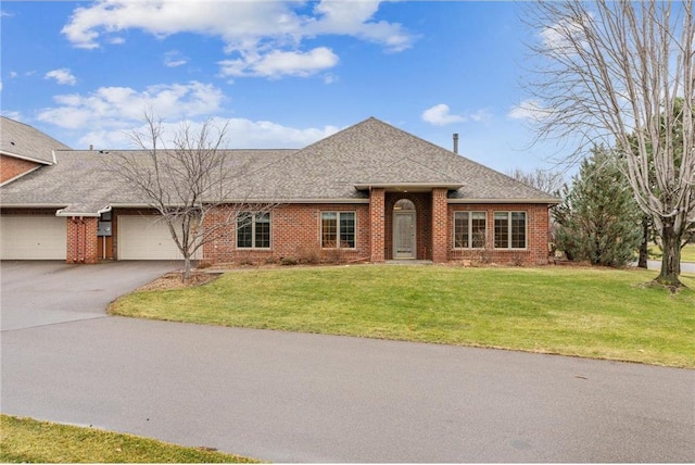 ranch-style home with a front lawn and a garage