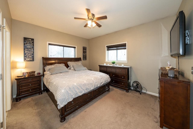 bedroom with baseboards, light carpet, and a ceiling fan