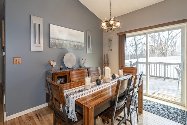 W3769 Alder Dr, Lake Geneva, WI 53147 - dining room featuring a chandelier, light wood-style flooring, and lofted ceiling