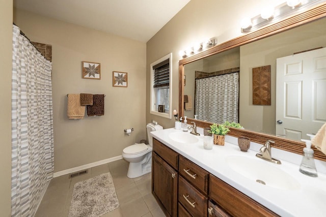 bathroom with a sink, visible vents, toilet, and tile patterned flooring