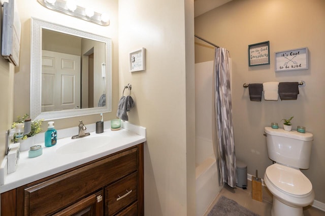 bathroom with vanity, baseboards, tile patterned flooring, shower / bath combination with curtain, and toilet