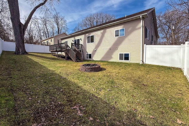W3769 Alder Dr, Lake Geneva, WI 53147 - rear view of house featuring an outdoor fire pit, a wooden deck, a fenced backyard, and stairs
