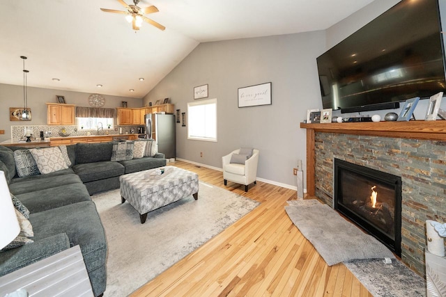 W3769 Alder Dr, Lake Geneva, WI 53147 - living room featuring lofted ceiling, ceiling fan, light wood-type flooring, and a fireplace