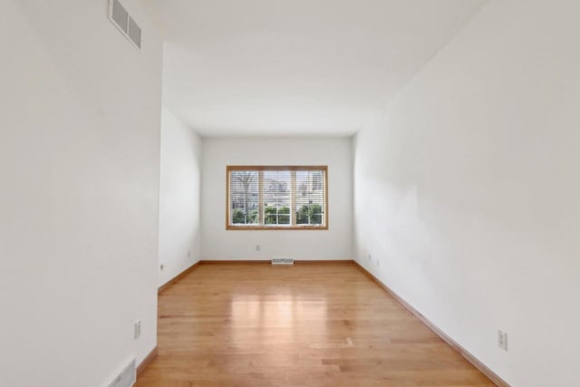 spare room featuring light wood-type flooring