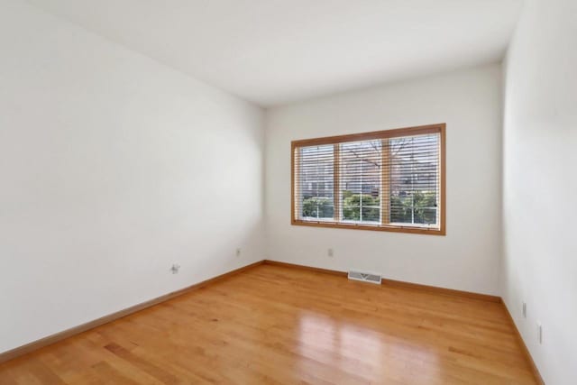 empty room with hardwood / wood-style flooring