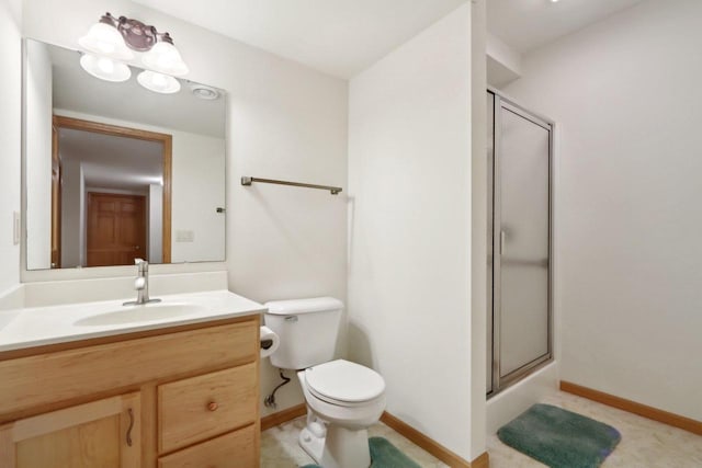 bathroom featuring toilet, vanity, and walk in shower