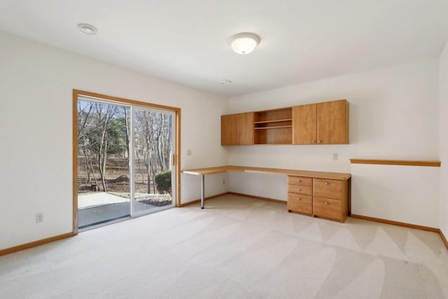 unfurnished office featuring light carpet and built in desk