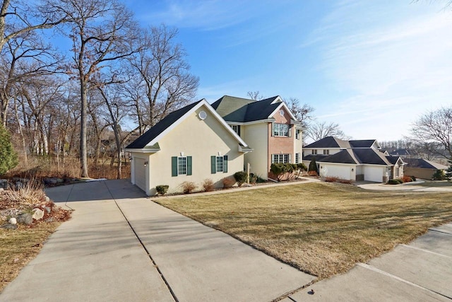 view of side of home with a lawn and a garage