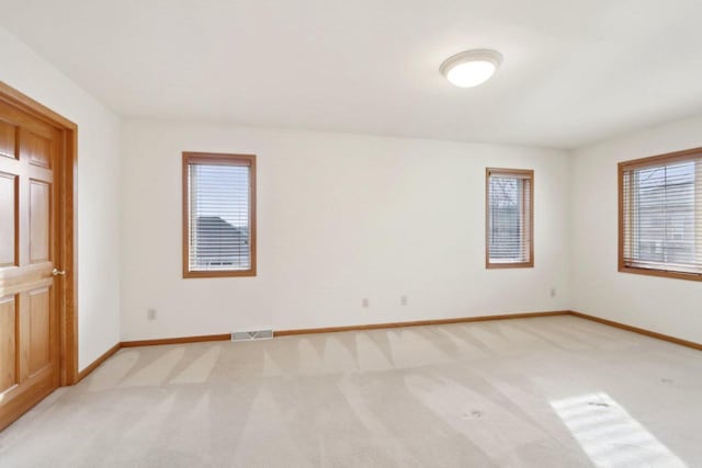 unfurnished room with light colored carpet