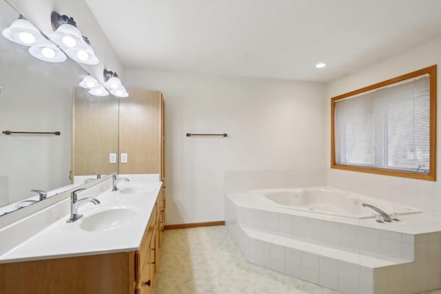 bathroom with vanity and tiled tub