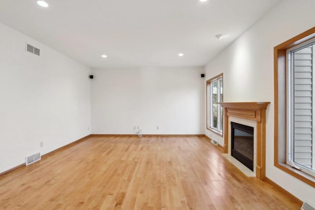 unfurnished living room with light hardwood / wood-style floors