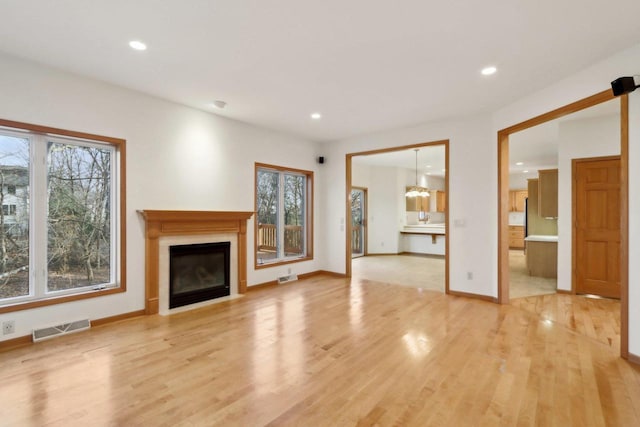 unfurnished living room with light hardwood / wood-style floors