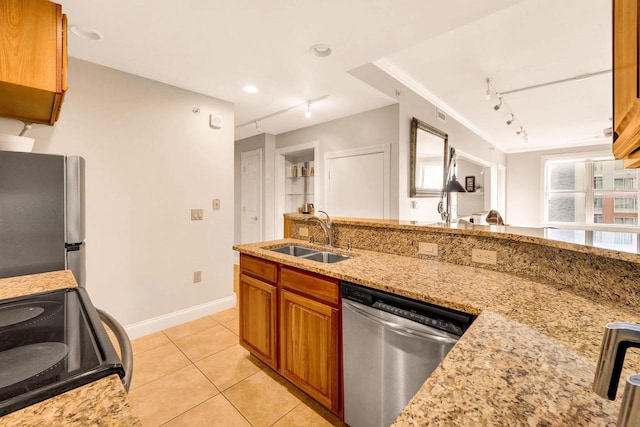 kitchen with light stone countertops, sink, light tile patterned floors, and appliances with stainless steel finishes