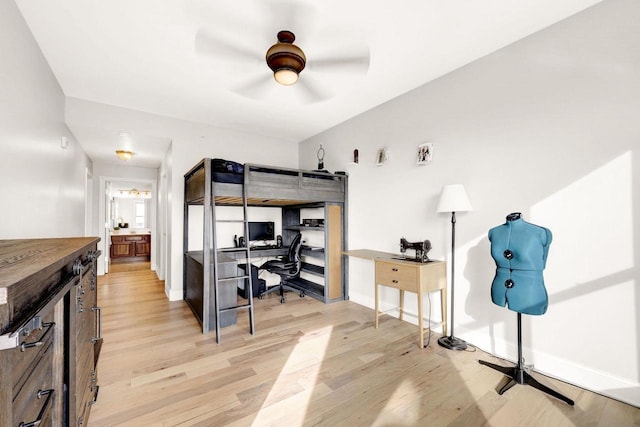 bedroom with connected bathroom, ceiling fan, and light hardwood / wood-style floors